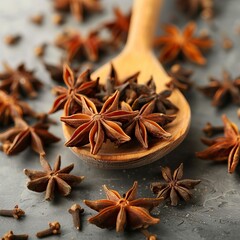 anise star spice for baking in wooden spoon on concrete table
