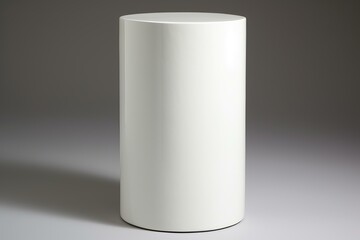 Simple white cylindrical shape stands against a seamless gray backdrop