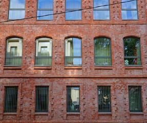 view of facade of historical red brick building arched windows