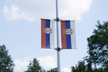Two Serbian flags displayed on a pole