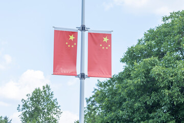 Two chinese flags displayed on a pole
