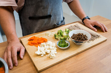 Chef at the kitchen preparing japanese buckwheat pasta with lentils