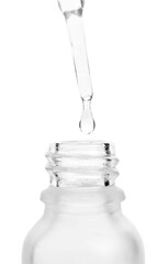 Dripping liquid from pipette into bottle isolated on white, closeup