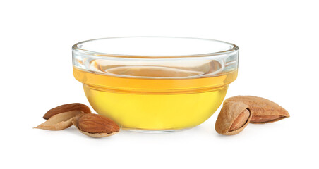 Almond oil in bowl and fresh nuts isolated on white