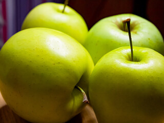 A quartet of shiny green apples, closely grouped. This image suggests natural, wholesome food choices for consumers.