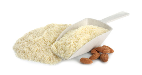 Pile of fresh almond flour, nuts and scoop isolated on white