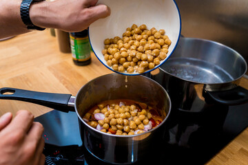 Chef at the kitchen preparing massaman curry with sweet potato and many spices