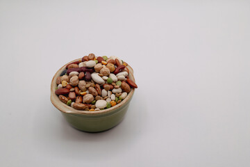 Assorted dried beans in a bowl with white background 