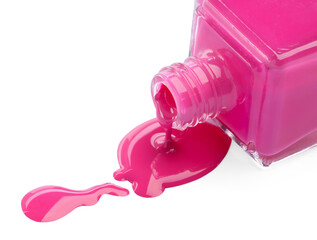 Bottle and spilled pink nail polish isolated on white