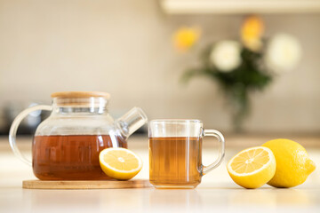 cup of tea with lemon on light background