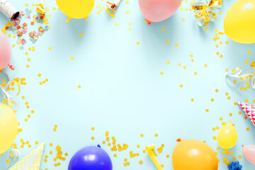 Frame of decoration birthday party on a pastel blue background with copy space top view