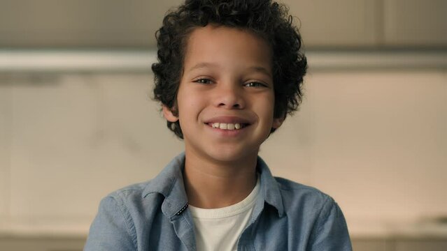 Portrait little African American boy child son schoolboy happy joyful smiling male pupil school kid junior orphan carefree funny toddler baby face purity smile laugh at home children custody adoption