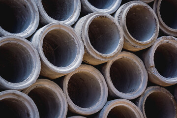 A stack of concrete ring pipes piled and creating a symmetrical arrangement