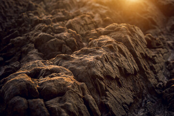 A large rocks surrounded by waves of the ocean