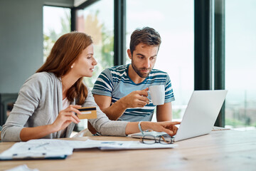 Credit card, laptop and couple at table in morning for online shopping with purchase in house on...