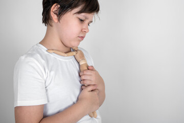 Sad teenager hugs the only friend - wooden man. Depression, anxiety, stress, loneliness and mental health concept