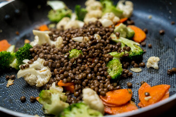Chef at the kitchen preparing japanese buckwheat pasta with lentils