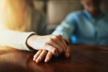 Support, care and trust with hands of people at wooden table together for hope, empathy and love....