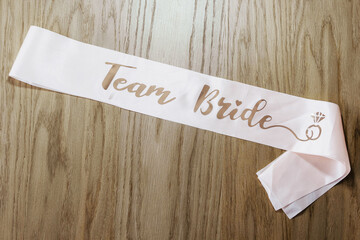 Sash team bride. Team bride. Bride to be. Wooden background. Png. hen party. bachelorette party. Sash. Bride’s Party. Bachelorette Bash. design element	