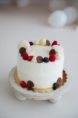Happy birthday cake with berries, macrons and chocolate