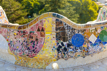 Serpent bench made of mosaic tiles in Park Guell in Barcelona. UNESCO World Heritage Site. Concept of travel, tourism and vacation