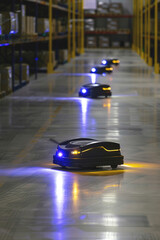 Automated guided vehicles in warehouse: Robots moving pallets within a high-tech logistics center.