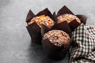 Homemade delicious wholegrain muffins on gray background