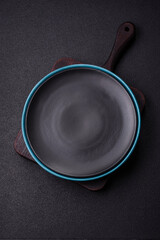 Empty ceramic round plate on dark textured concrete background