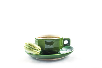 One green cup of coffee and french macaroon on a white background