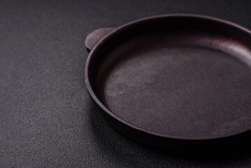 Empty ceramic round plate on dark textured concrete background