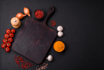 Empty wooden cutting board with spices, salt and herbs
