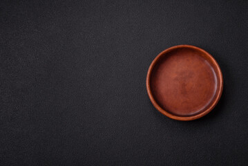 Empty ceramic round plate on dark textured concrete background