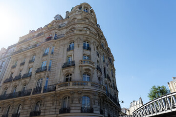 Fototapeta premium The facade of traditional French house with typical balconies and windows. Paris.