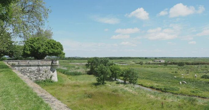 The high ramparts of the ancient royal city of Hiers-Brouage dominating the Charentais marsh and its canals