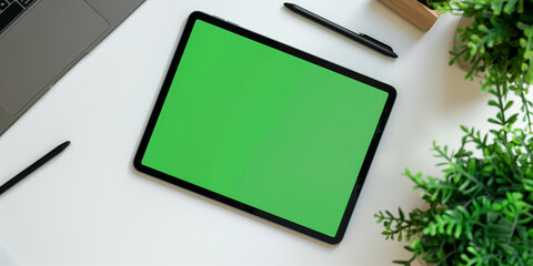 iPad Pro showing a green screen beside a pin on a white table