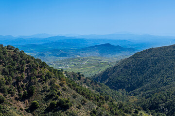 Obraz premium Panoramic view from hiking trail to waterfalls over river Caballos, Sierra de la Nieves National Park in Tolox, Malaga, Spain