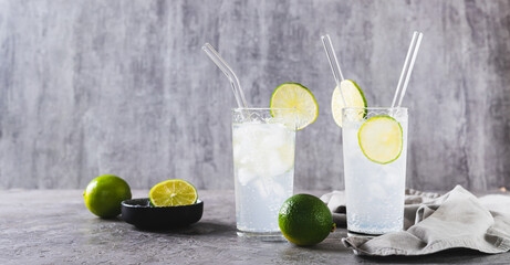 Refreshing summer mojito cocktail with ice and lime in glasses on the table web banner