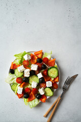 Greek salad with vegetables tomato, cucumber, lettuce, feta in plate
