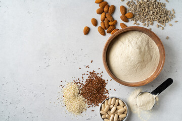 Different protein powder in bowls with nuts and seeds