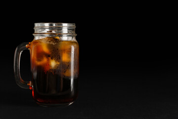 Mason jar of tasty kvass on black background