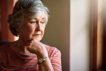Thinking, anxiety and senior woman in home living room to remember memory, stress or reflection of...