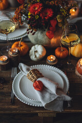 Fall table decoration with pumpkins, wine. Family cozy thanksgiving dinner arrangement indoors at home, wedding elegant decor. Countryside style, simple handmade setting, autumn mood, inspiration.