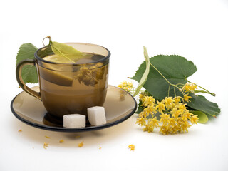 Cup of linden tea and linden flowers