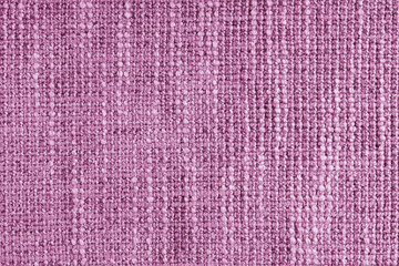 Jacquard woven coarse weave texture upholstery pink fabric. Textile background, furniture textile material, wallpaper, backdrop. Cloth structure close up, macro.