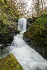 Long exposure of a waterfall on the Hoar Oak Water river at Watersmeet in Exmoor National Park
