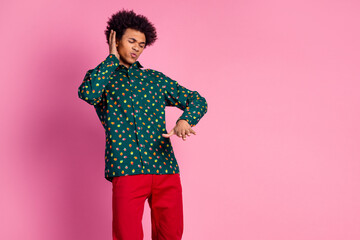 Portrait of cool positive focused guy with wavy hairstyle dressed print shirt dancing on disco...