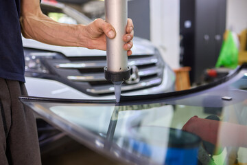 Use professional adhesive when repairing windshield glass for autos to ensure a secure installation