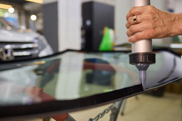Use professional adhesive when repairing windshield glass for autos to ensure a secure installation