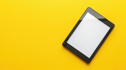 Contemporary e reader with screen on yellow background top down view Text space