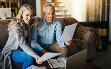 Happy couple, reading and insurance with paperwork for budget planning, bills or expenses on sofa...